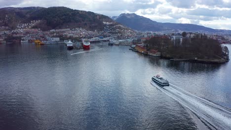 Express-boat-approaching-Bergen-harbour-with-passengers-during-morning-rush---Aerial-follow-Norway