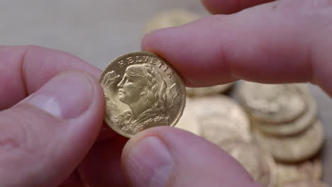 Person-holding-polished-golden-twenty-franc-coin-from-year-1947,close-up