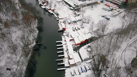 Top-aerial-view-of-abandoned-wharfs-after-the-first-snowfall-of-winter,-Sweden
