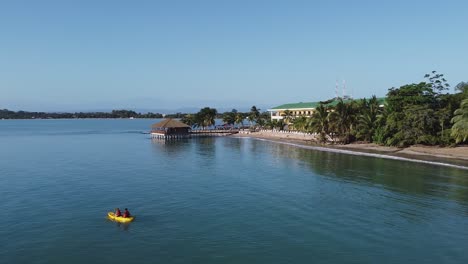 Panama-aerial:-Kayakers-paddle-at-Playa-Tortuga-with-hotel-resort-dock