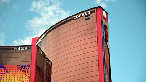 Resorts-World-Hotel-and-Casino-side-exterior-shot-with-Conrad-and-Hilton-logos