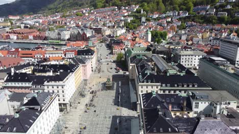 Closeup-aerial-of-Torgallmenningen-city-square-Bergen---Reversing-with-tilt-up-to-reveal-big-city-overview-from-the-air---Norway