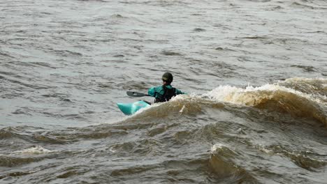 Kayaker-rips-a-swell-created-by-the-rapids-on-the-Ottawa-River-during-high-flood-season