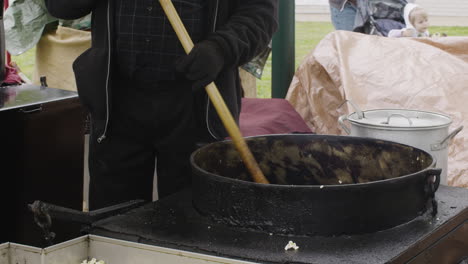 Person-cooking-a-large-vat-of-street-food-at-a-festival---Dogwood-Festival-Siloam-Springs-Arkansas-USA