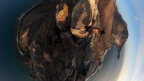 Vertical-360-footage-of-a-man-hiking-on-the-cliff-on-Porto-Santo-island-in-the-sunset