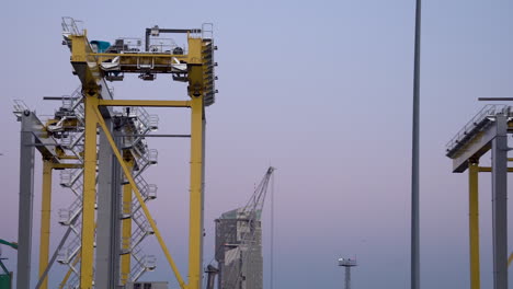 Panning-shot-of-industrial-sea-tower-at-harbor-of-Gdynia-during-blue-hour,Poland