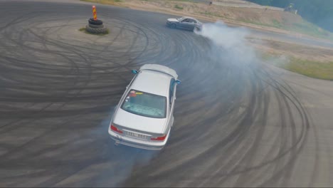 Two-BMW-cars-doing-a-burnout