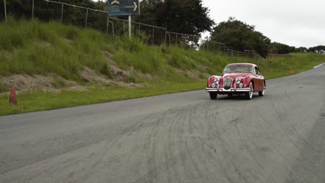 antique-english-car-jagaur-red-on-race-track