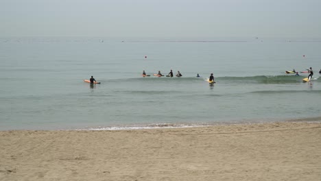 Surfers-Off-The-Shore-Of-Songjeong-Beach-In-Busan,-South-Korea-After-Summer-Season