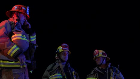 firefighters-standing-by-engine-hd