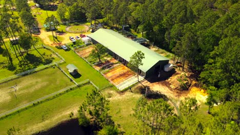 A-drone-delivers-a-dramatic-perspective-up-high-of-a-horse-ranch-near-the-ocean-in-sunny-Florida