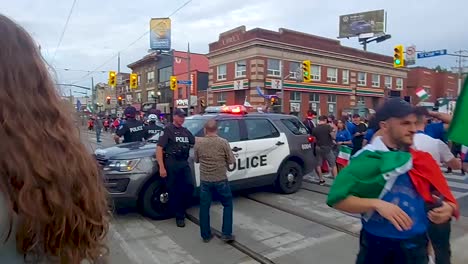 Police-block-traffic-as-fans-celebrate-Italy's-Euro-Cup-Win,-Corso-Italia,-Toronto