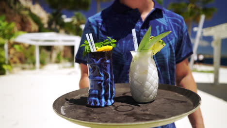 Beach-waiter-serving-fruit-cocktail-in-style-at-Mallorca-Spain