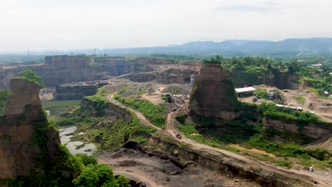 Brown-Canyon-opencast-mine-in-Java,-Indonesia,-aerial-revealing-quarry-landscape