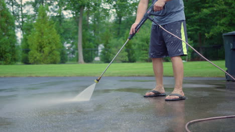 Cropped-Image-Of-A-Man-Cleaning-Asphalt-Ground-With-A-Pressure-Washer