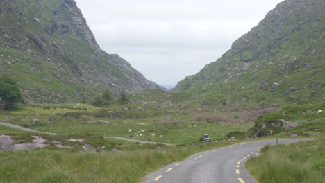 Car-Traveling-At-The-Winding-Road-Of-The-Gap-Of-Dunloe-In-Killarney-National-Park-In-Ireland