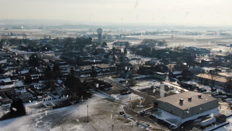 AERIAL-Snow-Falls-Over-American-Township-On-Grey-Winter-Day