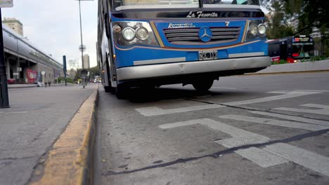 Low-angle-shot-of-old-colorful-mercedes-bus-arriving-bus-station-in-Buenos-Aires