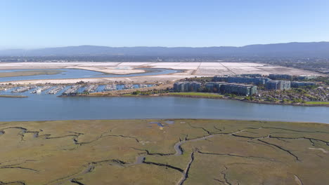 Aerial-of-Marina,-Corporate-Buildings,-Salt-Flats,-and-Wetlands-in-SF-Bay-Area