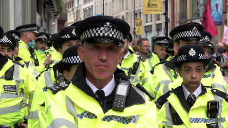A-slow-motion-shot-of-a-unit-of-Metropolitan-police-officers-stand-awaiting-orders-while-policing-an-Extinction-Rebellion-climate-change-protest
