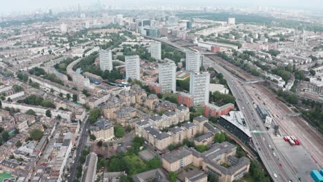 Pan-up-drone-shot-towards-city-skyline-from-residential-west-London-westway