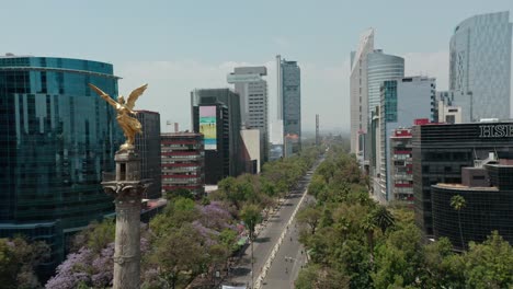 Aerial-dolly-right-shot-above-reforma-cityscape-at-day,-wide-angle