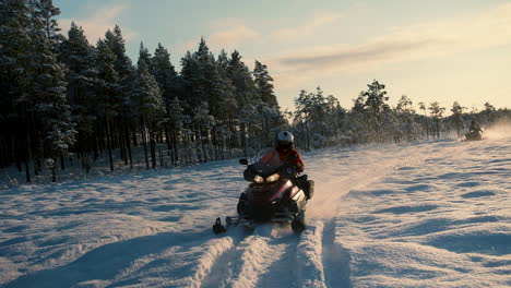 Snowmobiles-riding-from-the-sun-on-a-sunny-winterday-in-slowmotion