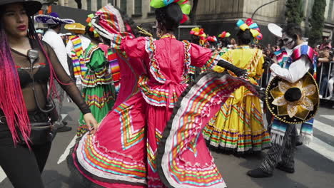 A-Woman-dancing-at-the-Day-of-the-Dead-parade-in-Mexico-City-wearing-a-traditional-colourful-Mexican-dress