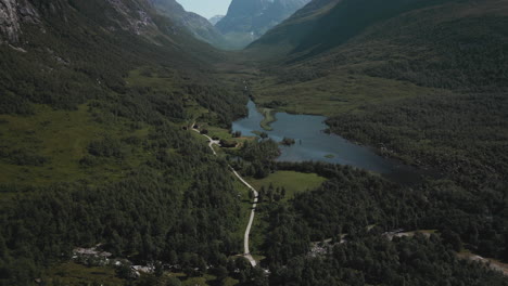 Mountain-Lodge-On-The-Lakeshore-Meadow-With-Dense-Foliage-In-Innerdalen-Valley-In-Norway