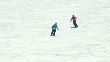 A-Couple-Of-Tourists-Enjoy-Skiing-At-The-Snowy-Landscape-In-Okuhida-Hirayu-Resort-At-Gifu-Prefecture,-Japan