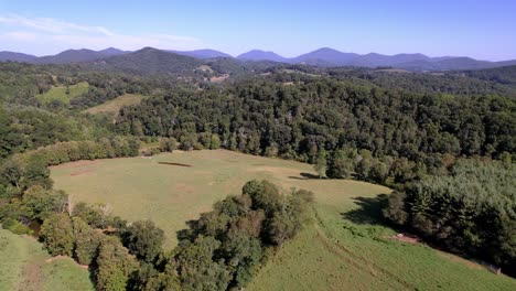 Snake-Mountain-NC,-North-Carolina-in-background-with-pastureland-in-foreground-aerial-in-watauga-county-nc,-north-carolina-near-boone-and-blowing-rock-nc,-north-carolina