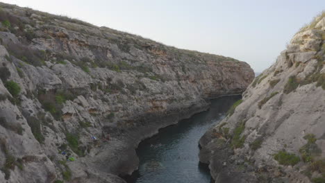 Stone-walls-of-the-Wied-il-Għasri-sea-canyon-valley,Malta,aerial-shot
