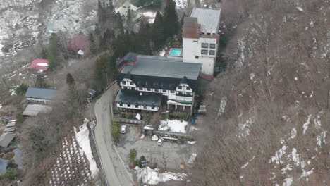 Aerial-View-Of-Hot-Spring-3-star-Hotel-With-Snow-On-A-Mountain