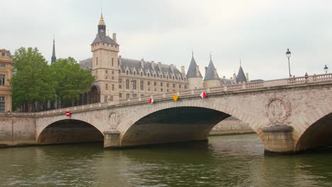 River-Traffic-underway-passing-under-the-Pont-au-Change-bridge-Seine-River,-Conciergerie-in-the-distance,-Seine-River,-4th-arrondissement,-Paris,-France