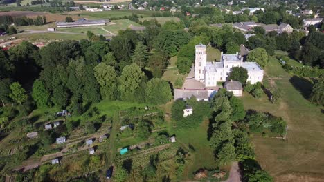 Vecauce-Manor-in-Latvia-Aerial-View-of-the-Pink-Castle-Through-the-Park