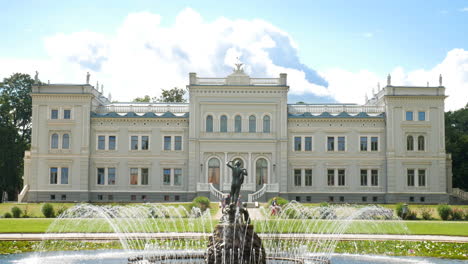 Main-entrance-of-Oginskis-manor-with-fountain-on-sunny-day-with-fluffy-clouds