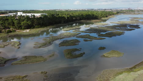 Flying-Over-Swampland-Towards-Small-Islets-On-A-Sunny-Day-In-Seixal,-Portugal