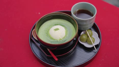 Green-Tea-Matcha-float-with-Green-Dango-in-Uji,-Close-Pan-Shot