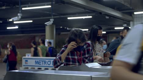 Passengers-at-the-metro-station-pay-their-fare-at-the-turnstile-ticket-gate-with-cards