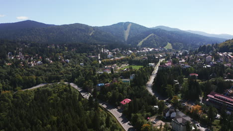 Aerial-View-Of-The-Predeal-Rural-Townscape-And-The-Beautiful-Clabucet-Mountains-In-Romania
