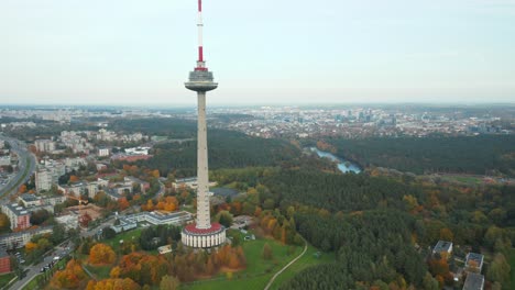 AERIAL:-Vilnius-TV-Tower-on-a-Autumn-Season-with-City-and-River-Neris-in-Background-During-Daytime