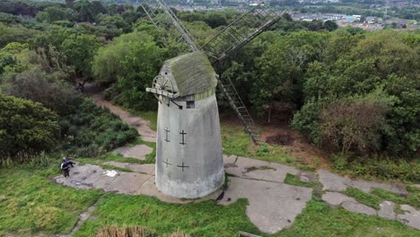 Bidston-hill-disused-rural-flour-mill-restored-traditional-wooden-sail-windmill-Birkenhead-aerial-rising-tracked-view-to-birdseye