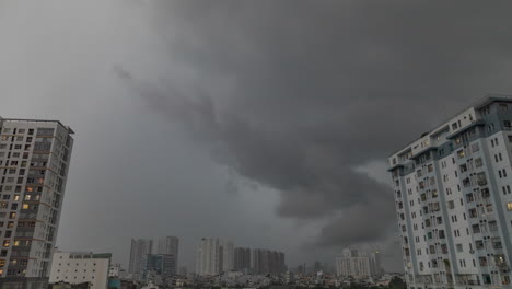 Heavy-tropical-rain-storm-over-residential-area-with-high-rise-buildings-framing-the-sky-time-lapse