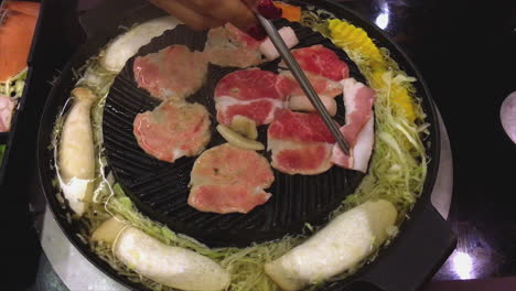 Japanese-Cuisine-Jingisukan-is-a-style-of-Japanese-cuisine-that-uses-dome-shaped-metal-skillet-to-cook-food-similar-to-barbecue,-in-which-items-of-food-on-skewers-are-slow-grilled-over-hot-plate