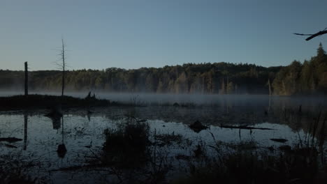 Right-to-left-panning-shot-of-morning-mist-rising-over-Lee-Lake
