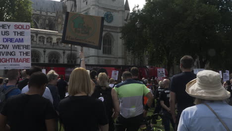 Camera-captures-a-large-number-of-people-rallying-together-with-placards-and-banners-in-Parliament-Square