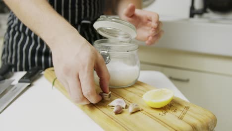 Chef-shows-various-ingredients-layed-out-on-wooden-cut-board