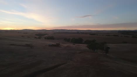 Aerial-flyover-rural-Endless-fields-during-Sunset,-Appila-Springs,-Australia