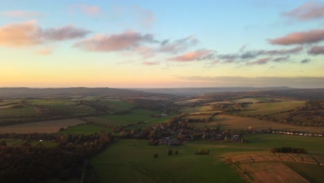 Aerial-view-of-a-sunset-over-English-countryside-with-fields-and-farmland