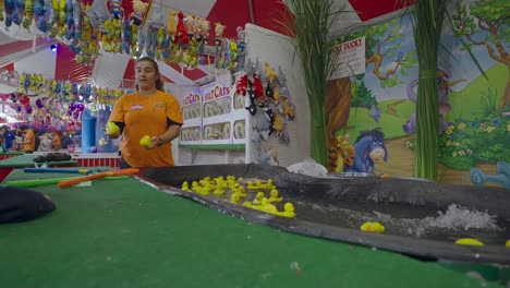 Boy-picks-two-winning-duckies-at-a-carnival-game,-and-is-a-winner